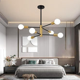 Modern bedroom with a stylish chandelier, bed, and decor.